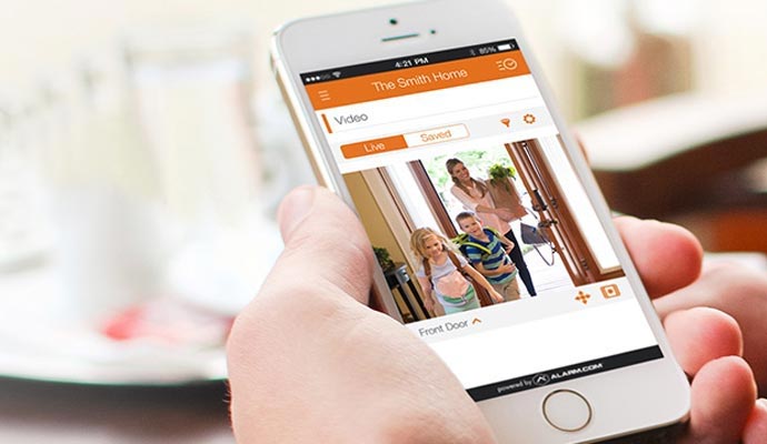Person using home security app on smartphone - Smart App for Home Security in Baton Rouge