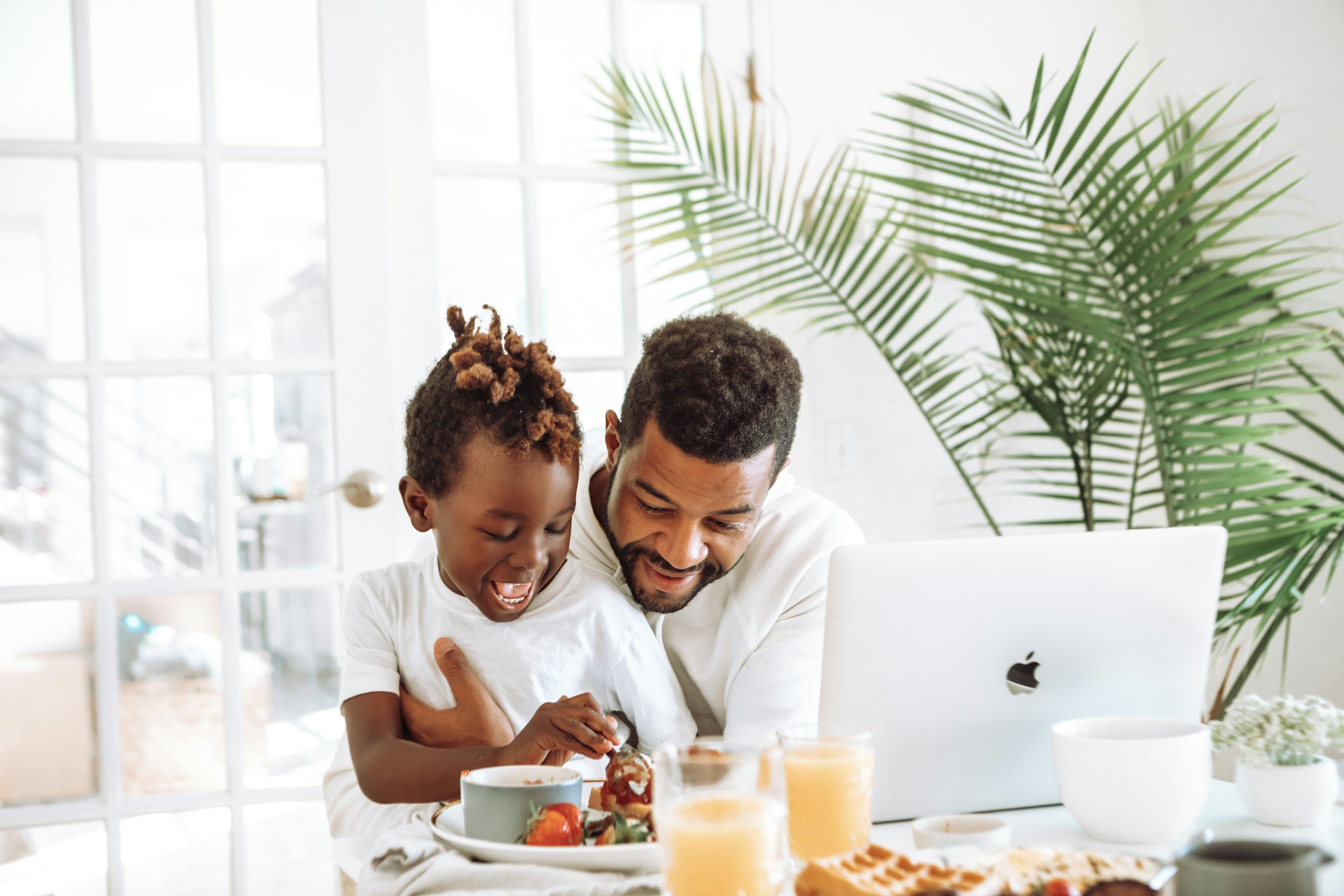 Keywords:
father working from home with child - man and woman sitting on white couch