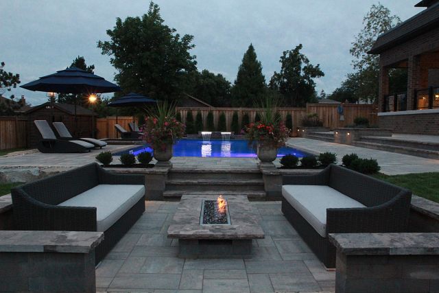 Luxury backyard patio with fire pit in winter - 10 Poolside Backyard Fire Pit Ideas | Latham Pool