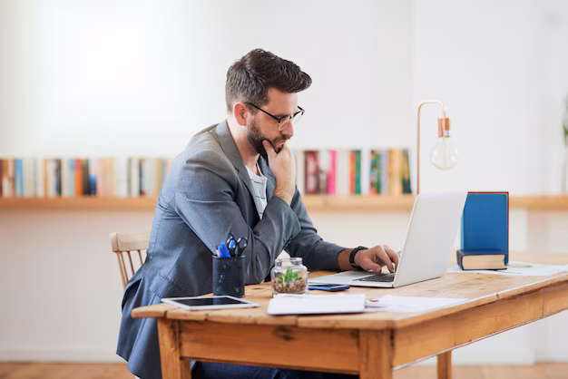 person writing book review on laptop - Remote work man and thinking at laptop for creativity idea or ...