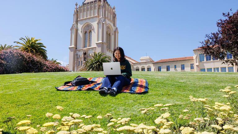 Urban gardener with laptop managing online store - Summer Sessions at USF - Admission & Aid | University of San Francisco