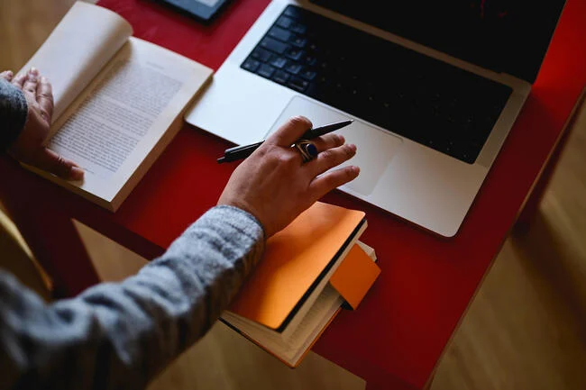 person writing book review on laptop - Why Review? (opinion)