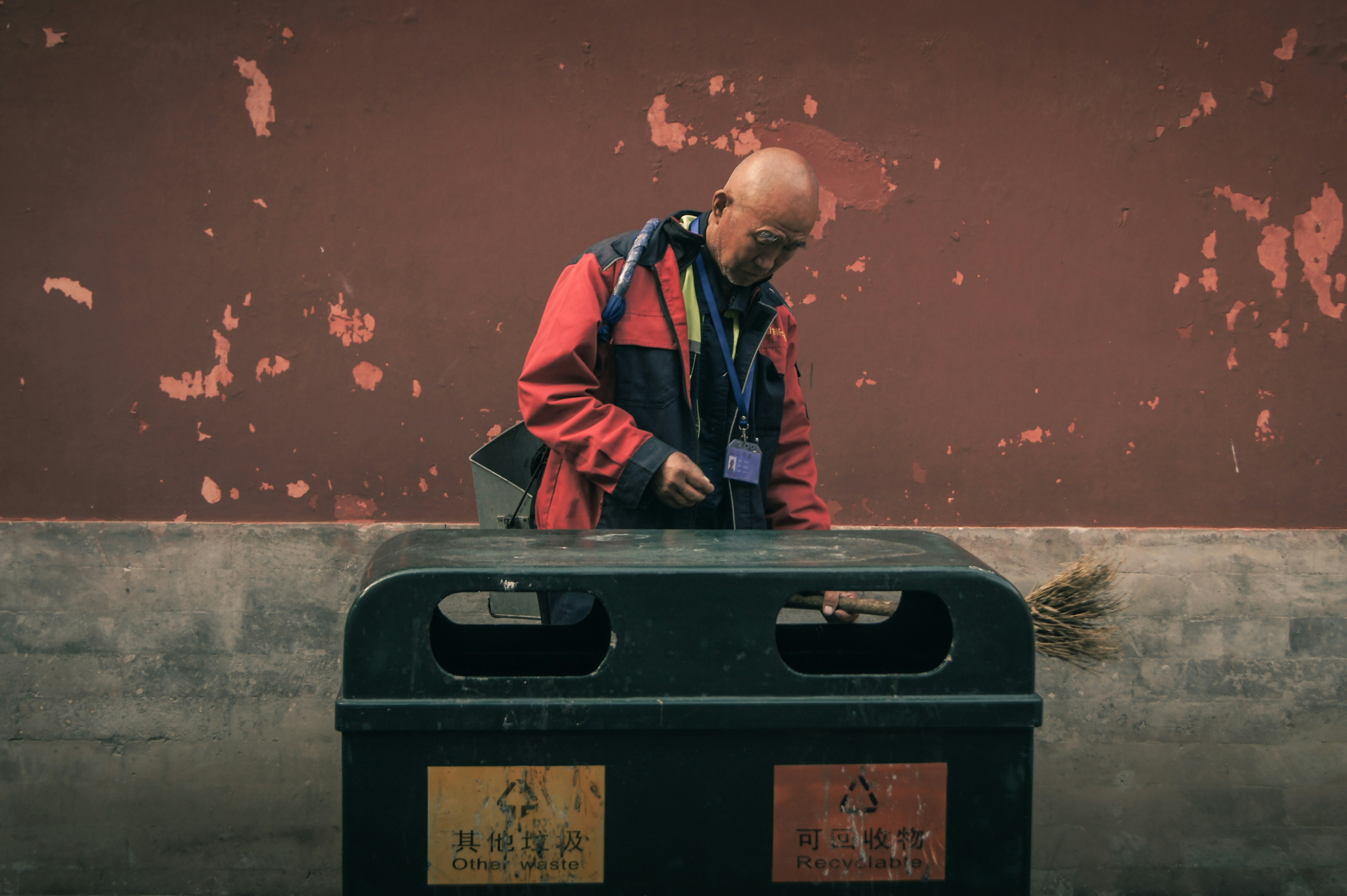Person sorting recycling into labeled bins at home - Cleaner in Summer Palace