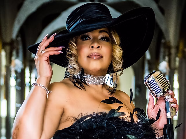 Cross necklace on singer at microphone - Mary Cross | Mary Cross