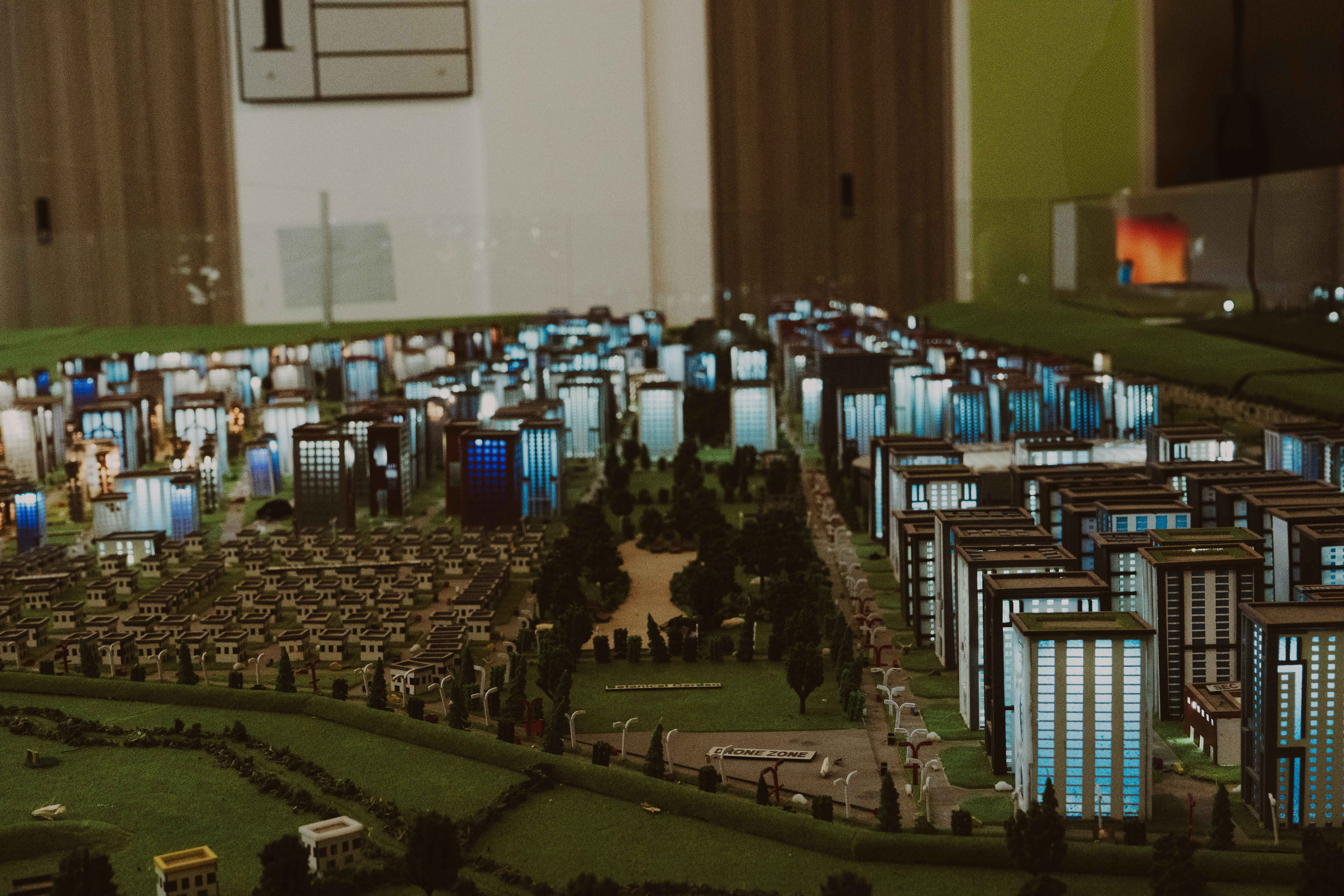 Futuristic city with data overlay - Miniature city model with buildings and trees.