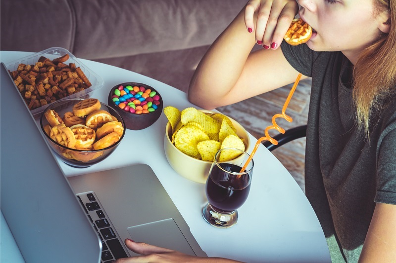 stressed woman emotional eating junk food - Stress & Eating Habits: How to Manage | Hackensack Meridian Health