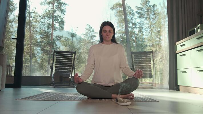 Keywords:
Woman meditating peacefully by window - Peaceful woman practicing yoga and meditation in modern home ...