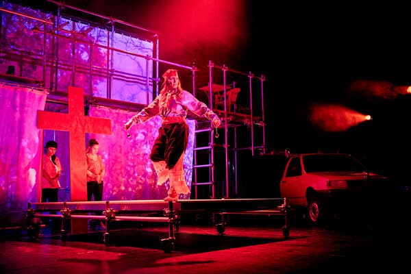 Stage lights shining on a cross - At Avignon Festival, Theater's World Gets Wider - The New York Times