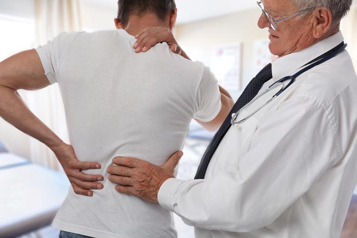 Doctor examining spine MRI - Diagnosing & Treatments for Ankylosing Spondylitis | WCM Center ...