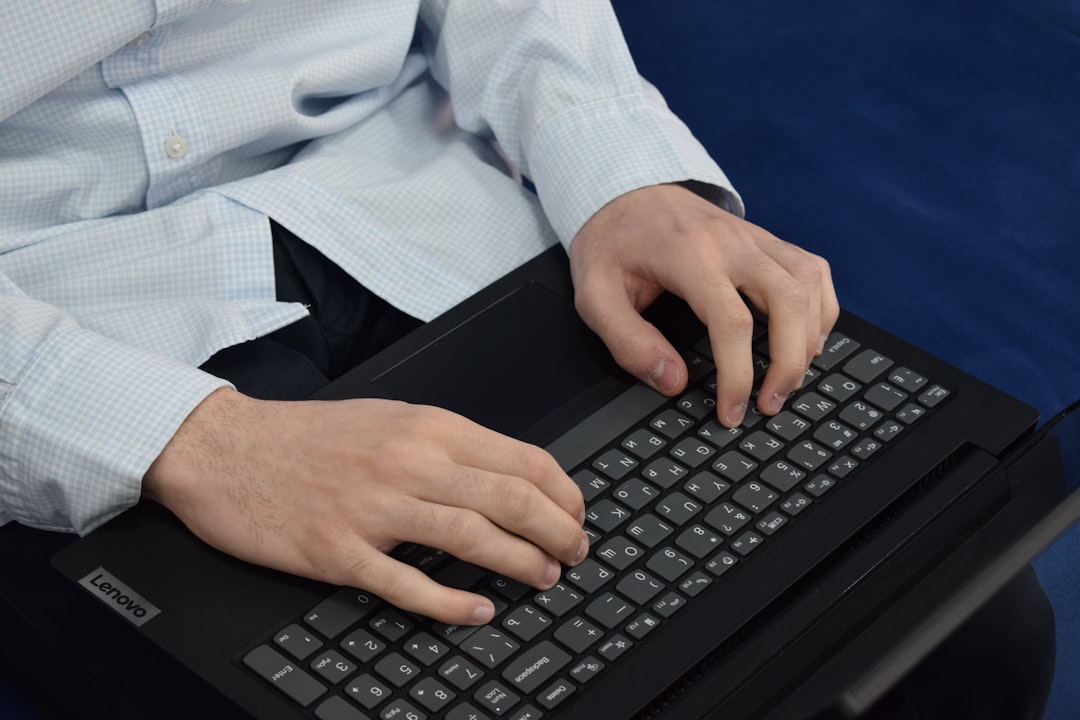 gavel on computer keyboard - Person typing on a laptop keyboard
